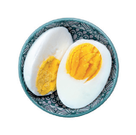 A hard-boiled egg, cut in half, is displayed in a small patterned bowl.