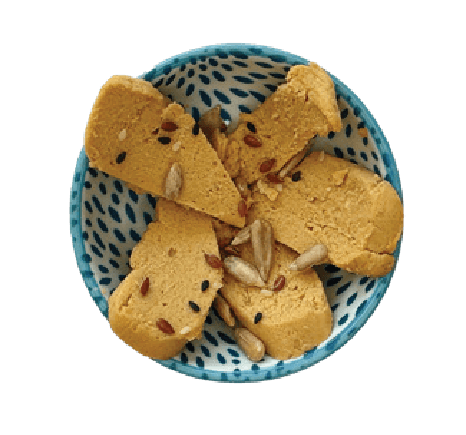 Homemade vegan cashew cheese in a small patterned bowl.
