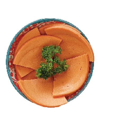 Slices of light brown processed meat, possibly bologna or mortadella, are arranged in a small patterned bowl with a parsley garnish.