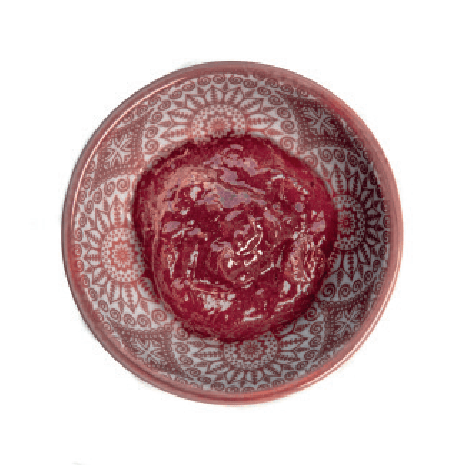 A dollop of locally-made jam is in a small, light-colored patterned bowl.