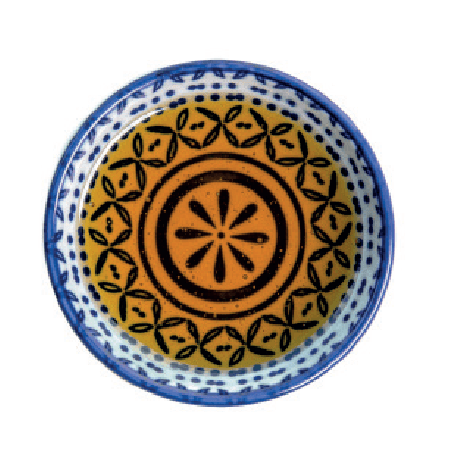 A small patterned bowl contains golden honey, showing the pattern of the bowl through it.
