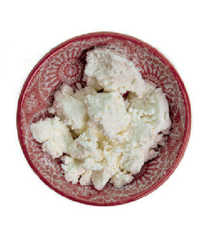 Crumbled goat cheese is presented in a small red patterned bowl.