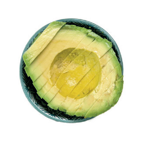 Half an avocado, sliced and fanned out, is presented in a small patterned bowl.