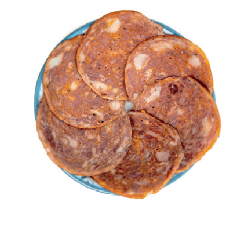 Several round slices of Spanish salami are fanned out on a small plate.