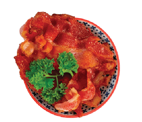 A small bowl of crispy fried bacon pieces is garnished with a sprig of parsley.