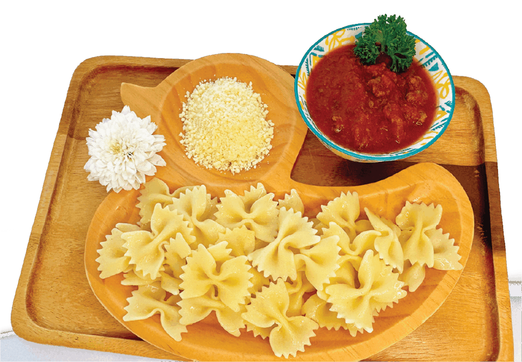 Bowtie pasta is served on a duck-shaped wooden plate with separate compartments for tomato sauce and parmesan cheese.
